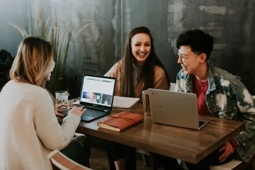 Three students learning together on laptops