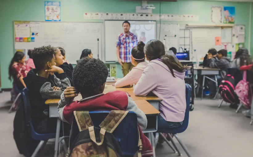 Teacher presenting to a class of school students