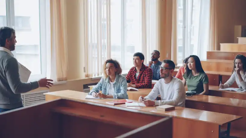Students listening to a lecture in a bright university classroom