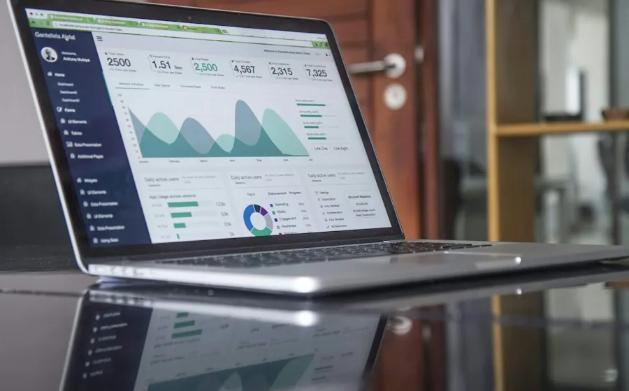 A laptop showing an analytics dashboard with charts